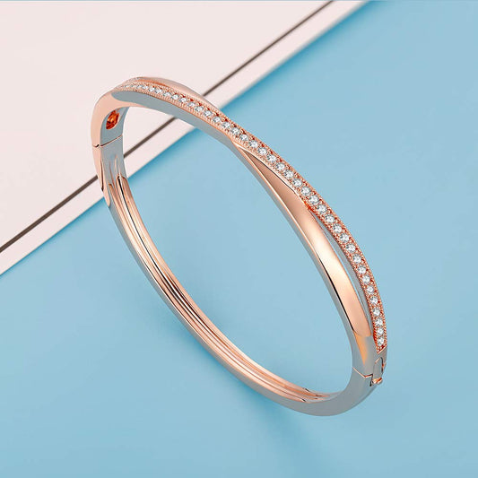 Twisted rose gold-bangle with radiant white crystal accents